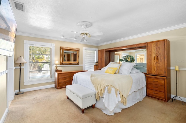 bedroom with a textured ceiling, light carpet, visible vents, baseboards, and ornamental molding