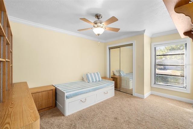 unfurnished bedroom featuring light carpet, a closet, baseboards, and crown molding