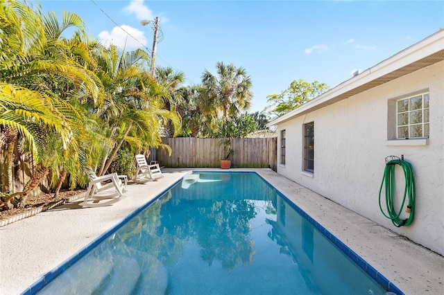 view of swimming pool with a patio area, a fenced backyard, and a fenced in pool