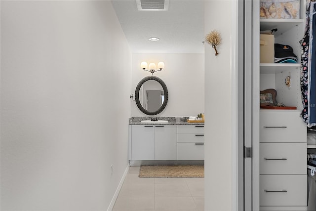 226 5th Ave N Unit 901, Saint Petersburg, FL 33701 - bathroom featuring baseboards, visible vents, tile patterned floors, a textured ceiling, and vanity