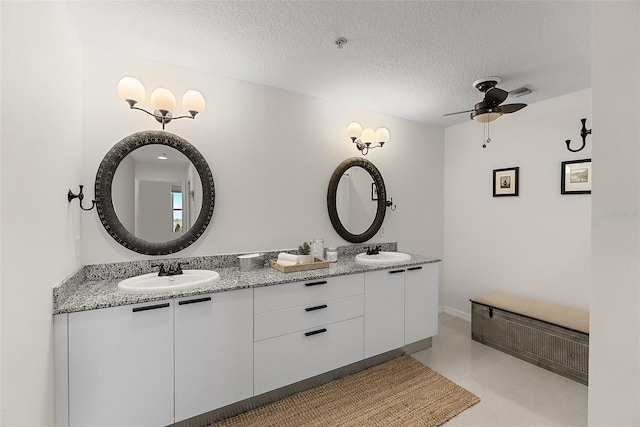226 5th Ave N Unit 901, Saint Petersburg, FL 33701 - full bathroom featuring a textured ceiling, double vanity, ceiling fan, and a sink