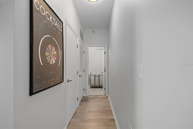 226 5th Ave N Unit 901, Saint Petersburg, FL 33701 - corridor with light wood-type flooring, baseboards, and a textured ceiling