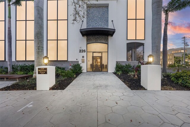 226 5th Ave N Unit 901, Saint Petersburg, FL 33701 - exterior entry at dusk with stucco siding