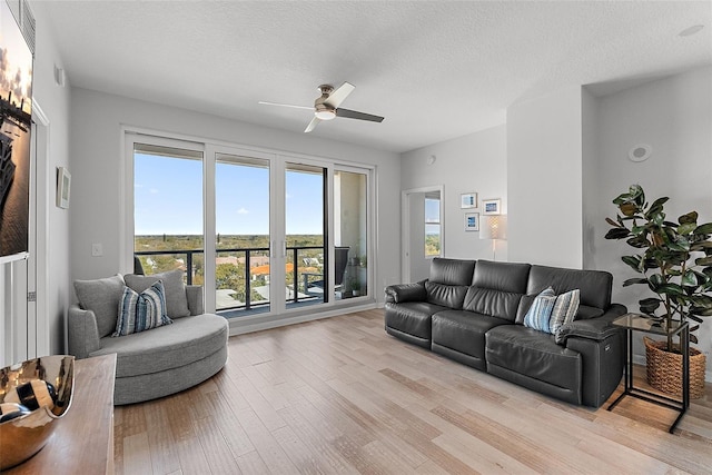 226 5th Ave N Unit 901, Saint Petersburg, FL 33701 - living area with a textured ceiling, a ceiling fan, and light wood-style floors