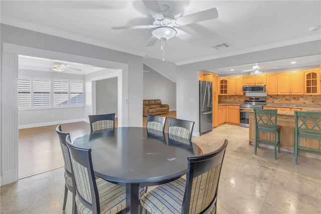 dining area featuring crown molding, a ceiling fan, and visible vents