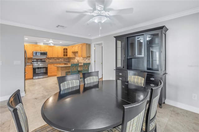 dining room with visible vents, crown molding, and baseboards