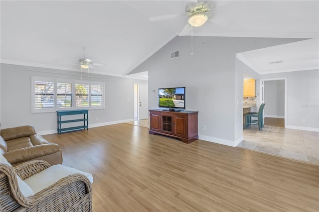 living area featuring visible vents, baseboards, light wood-style floors, and a ceiling fan