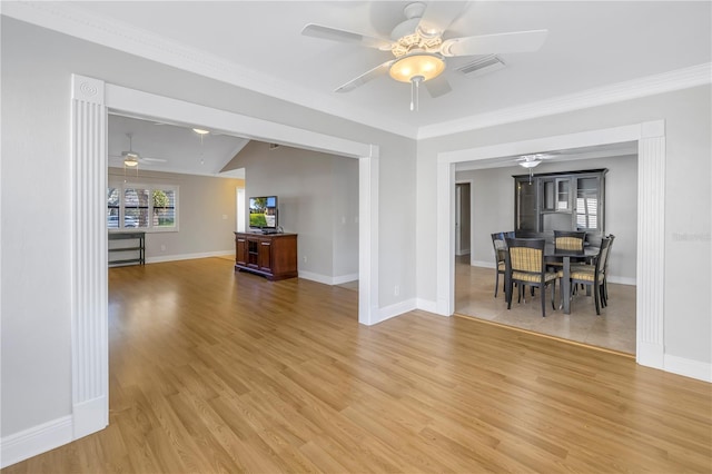 unfurnished dining area featuring crown molding, light wood-style floors, visible vents, and baseboards