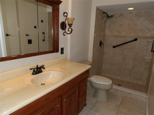 full bathroom with tile patterned flooring, vanity, a shower stall, and toilet