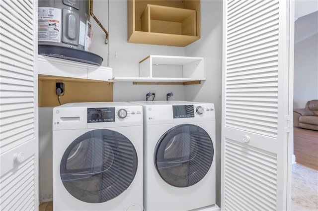 clothes washing area featuring washing machine and clothes dryer and laundry area