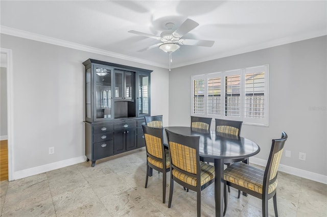 dining area featuring a ceiling fan, crown molding, and baseboards