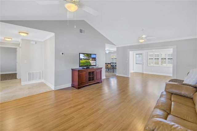 living area with visible vents, baseboards, light wood-type flooring, and a ceiling fan