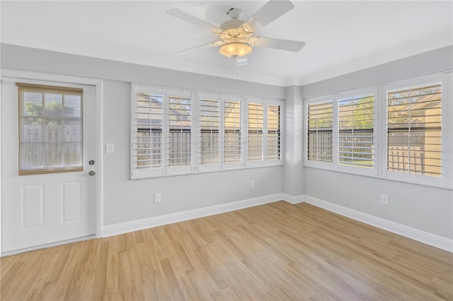 unfurnished sunroom with ceiling fan