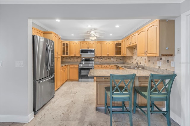 kitchen with glass insert cabinets, decorative backsplash, appliances with stainless steel finishes, a peninsula, and a sink