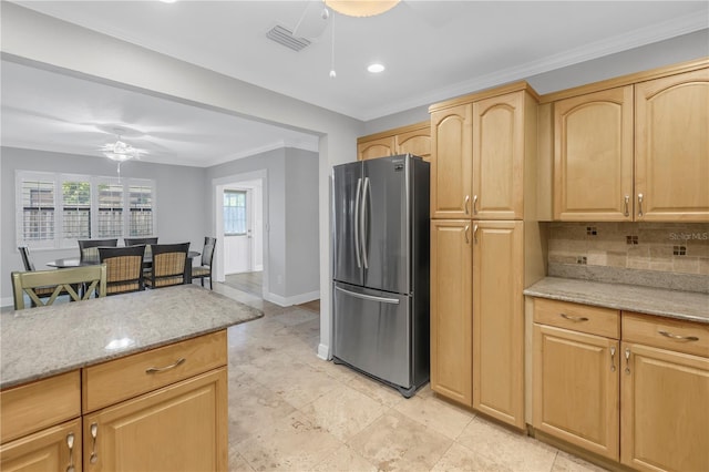 kitchen featuring visible vents, backsplash, light brown cabinets, freestanding refrigerator, and a ceiling fan