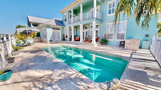 view of pool with a fenced in pool, fence, a patio, and french doors