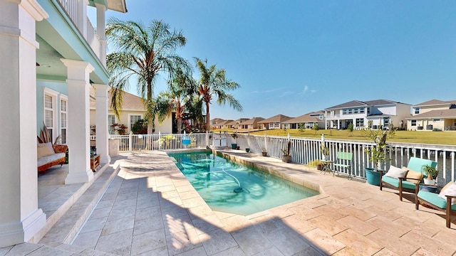 view of swimming pool featuring a patio area, a residential view, and a fenced in pool