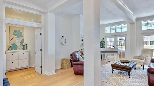 interior space with ornamental molding, wood finished floors, a textured ceiling, french doors, and beam ceiling