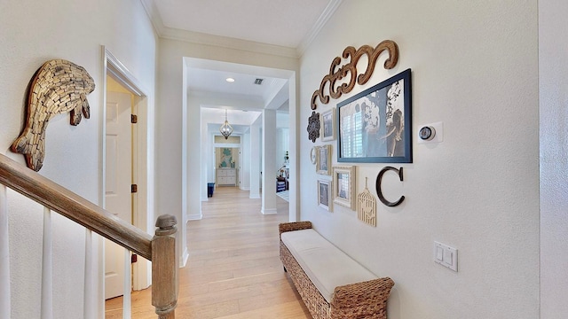 corridor featuring light wood finished floors, visible vents, stairway, ornamental molding, and baseboards