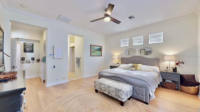 bedroom featuring light wood finished floors, visible vents, and ornamental molding