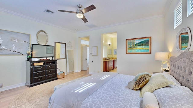 bedroom featuring light wood-type flooring, baseboards, visible vents, and crown molding