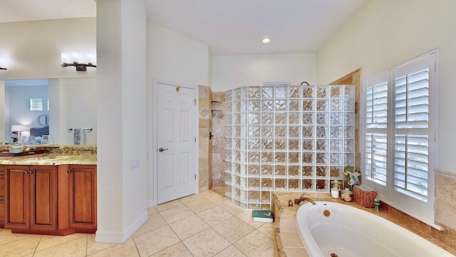 ensuite bathroom featuring a garden tub, vanity, ensuite bath, walk in shower, and tile patterned floors