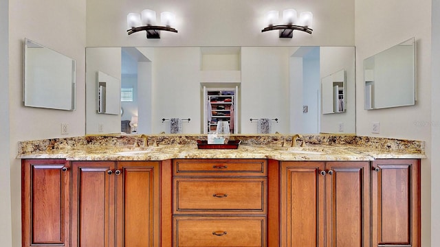 bathroom featuring a sink and double vanity