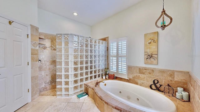 full bathroom featuring tile patterned flooring, a tub with jets, and walk in shower