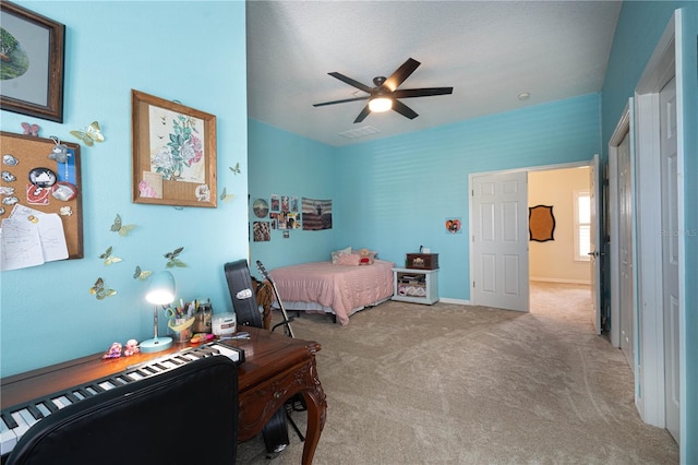 carpeted bedroom with a ceiling fan, visible vents, and baseboards