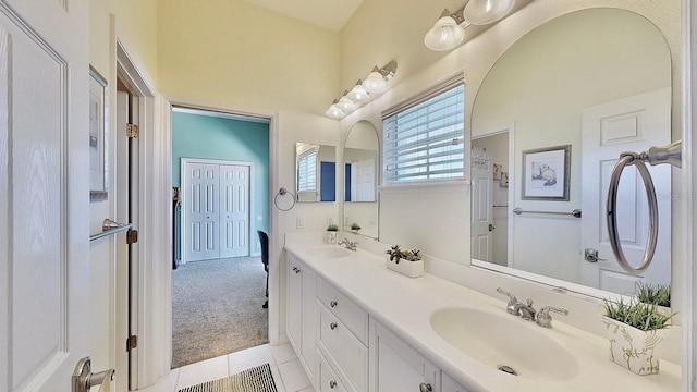 bathroom featuring double vanity, a sink, and tile patterned floors