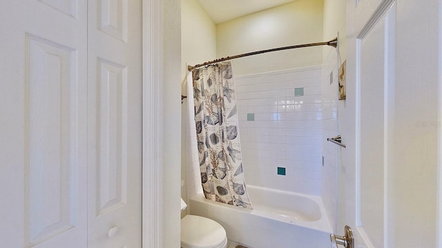 bathroom with toilet and shower / bath combo with shower curtain