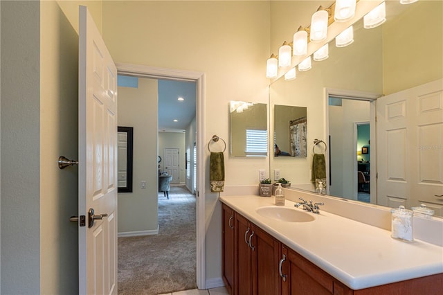 full bathroom with vanity and baseboards