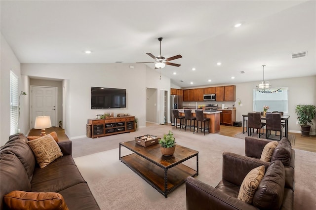 living area featuring vaulted ceiling, baseboards, visible vents, and recessed lighting