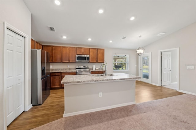 kitchen with stainless steel appliances, recessed lighting, visible vents, vaulted ceiling, and a sink