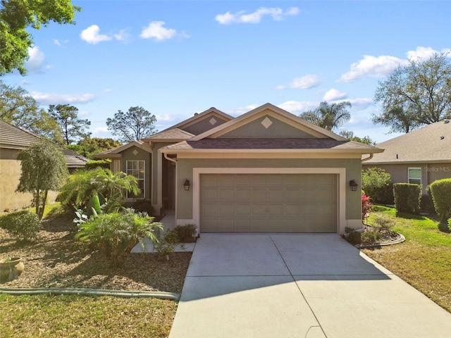 ranch-style home featuring a garage, roof with shingles, driveway, and stucco siding