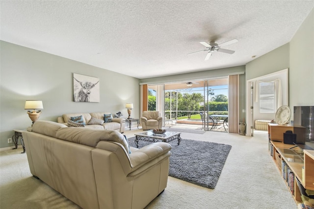 living room featuring ceiling fan, a textured ceiling, carpet, and a sunroom