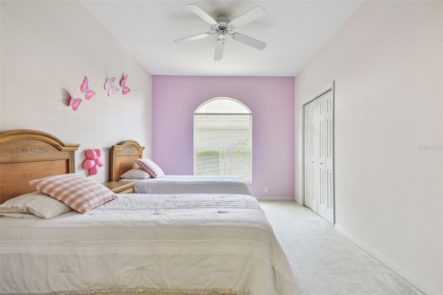 bedroom featuring a ceiling fan, a closet, carpet flooring, and baseboards