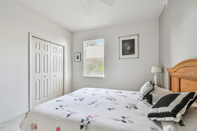 bedroom featuring ceiling fan, baseboards, a closet, and carpet flooring