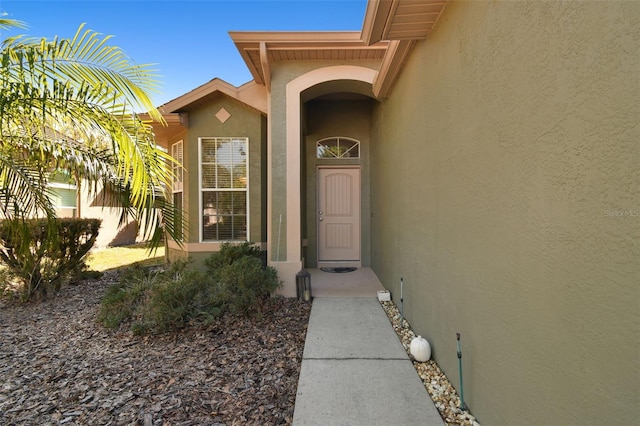 property entrance with stucco siding