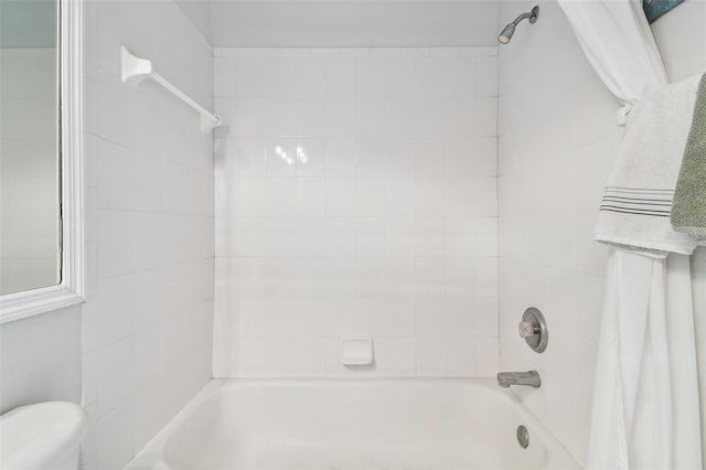 bathroom featuring shower / bathing tub combination and toilet