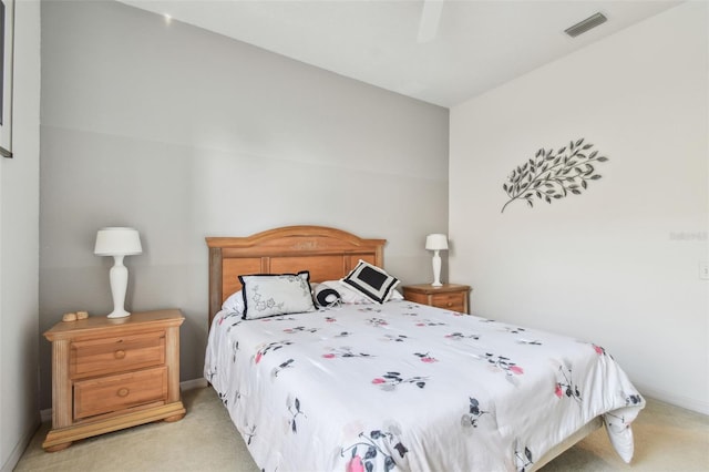 bedroom featuring baseboards, a ceiling fan, visible vents, and light colored carpet