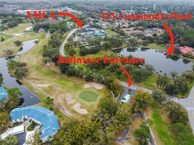 birds eye view of property featuring view of golf course and a water view