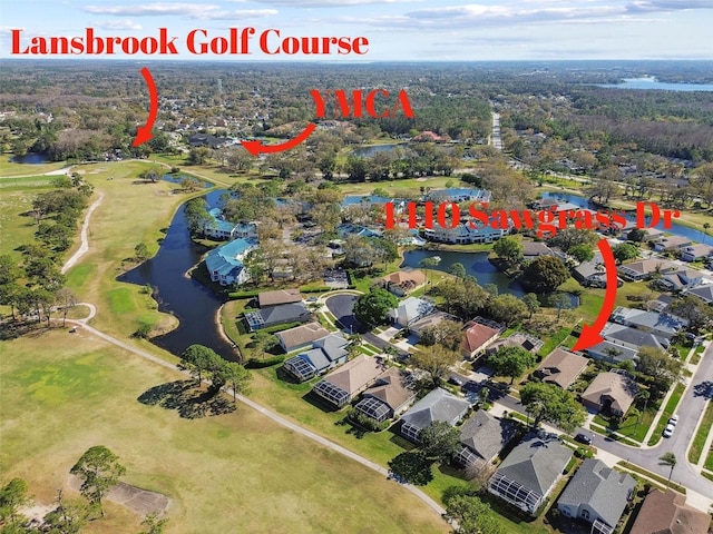 drone / aerial view with a water view and a residential view