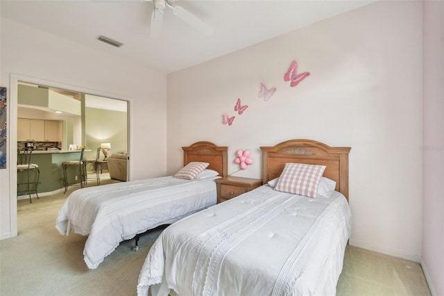 carpeted bedroom with baseboards, visible vents, and a ceiling fan