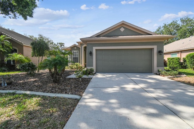 ranch-style house with stucco siding, a garage, and concrete driveway