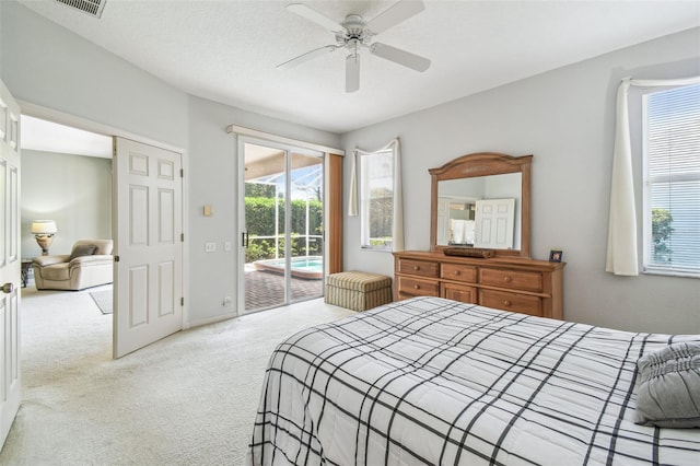 bedroom featuring a textured ceiling, carpet floors, ceiling fan, and access to outside
