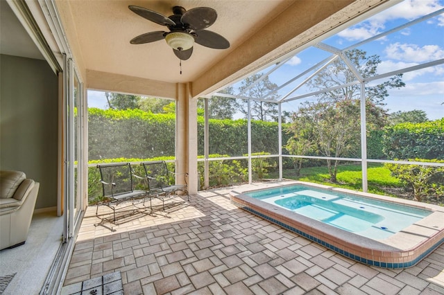 view of swimming pool featuring a lanai, an in ground hot tub, ceiling fan, and a patio