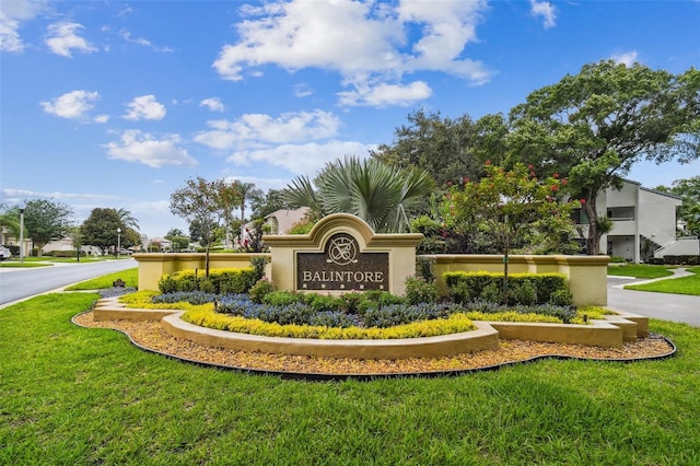 community sign featuring a yard