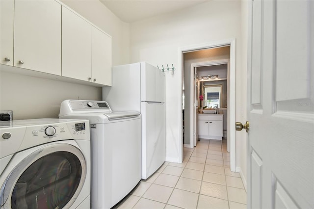 4410 Sawgrass Dr, Palm Harbor, FL 34685 - laundry room with cabinet space, separate washer and dryer, and light tile patterned flooring