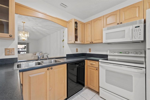 kitchen with dark countertops, light brown cabinetry, glass insert cabinets, a sink, and white appliances